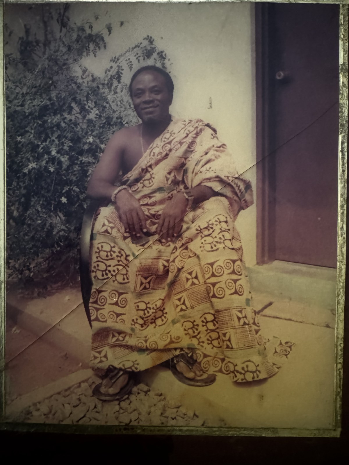 David Boa-Essilfie seated in traditional adinkra cloth